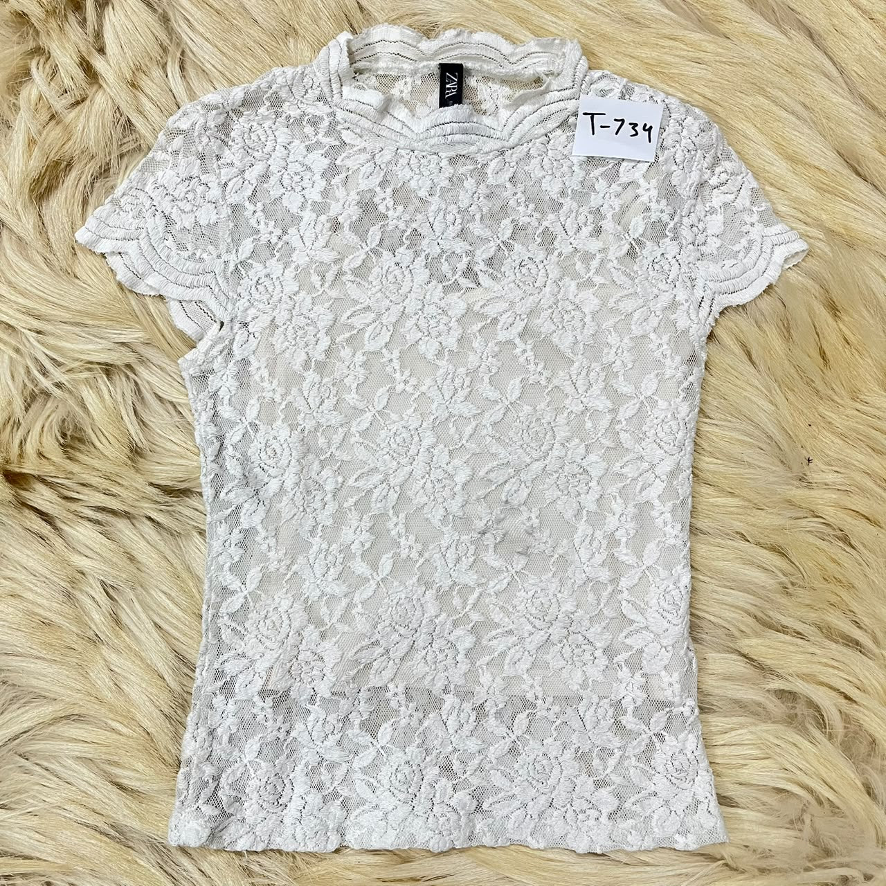 White floral lace top with a mock neck