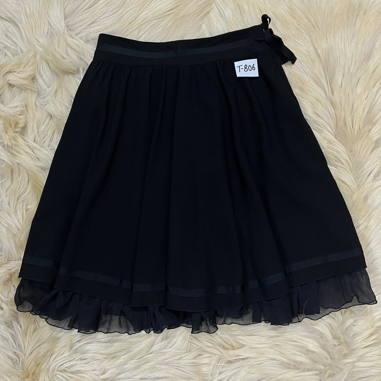 Pleated skirt with a sheer ruffled hem