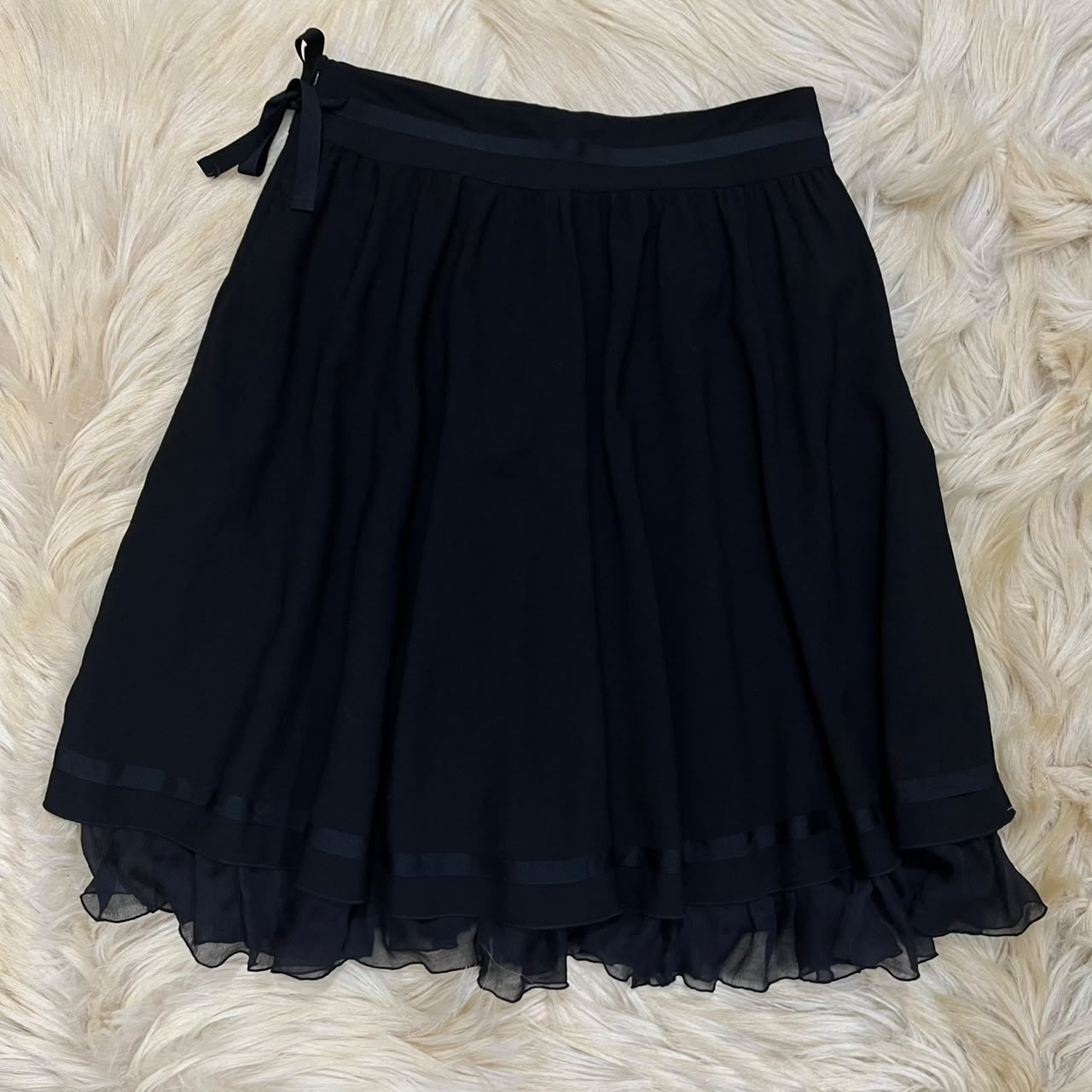 Pleated skirt with a sheer ruffled hem